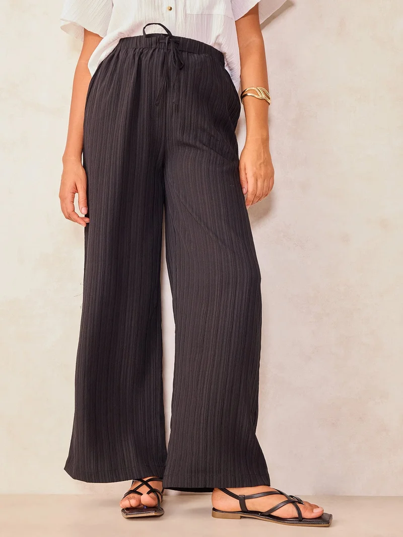 Outzidr  Black Textured Pull On Wide Leg Trouser for Women | Best Price UAE
